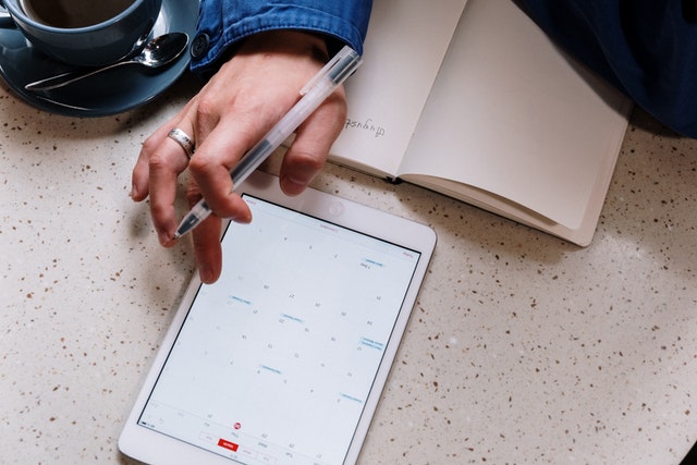 accessing a calendar on a tablet while taking notes