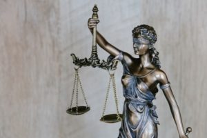 a justice statue holding law scales