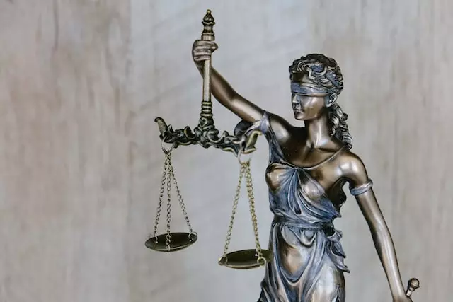 a justice statue holding law scales
