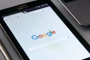 Close-up of a tablet displaying the Google home page