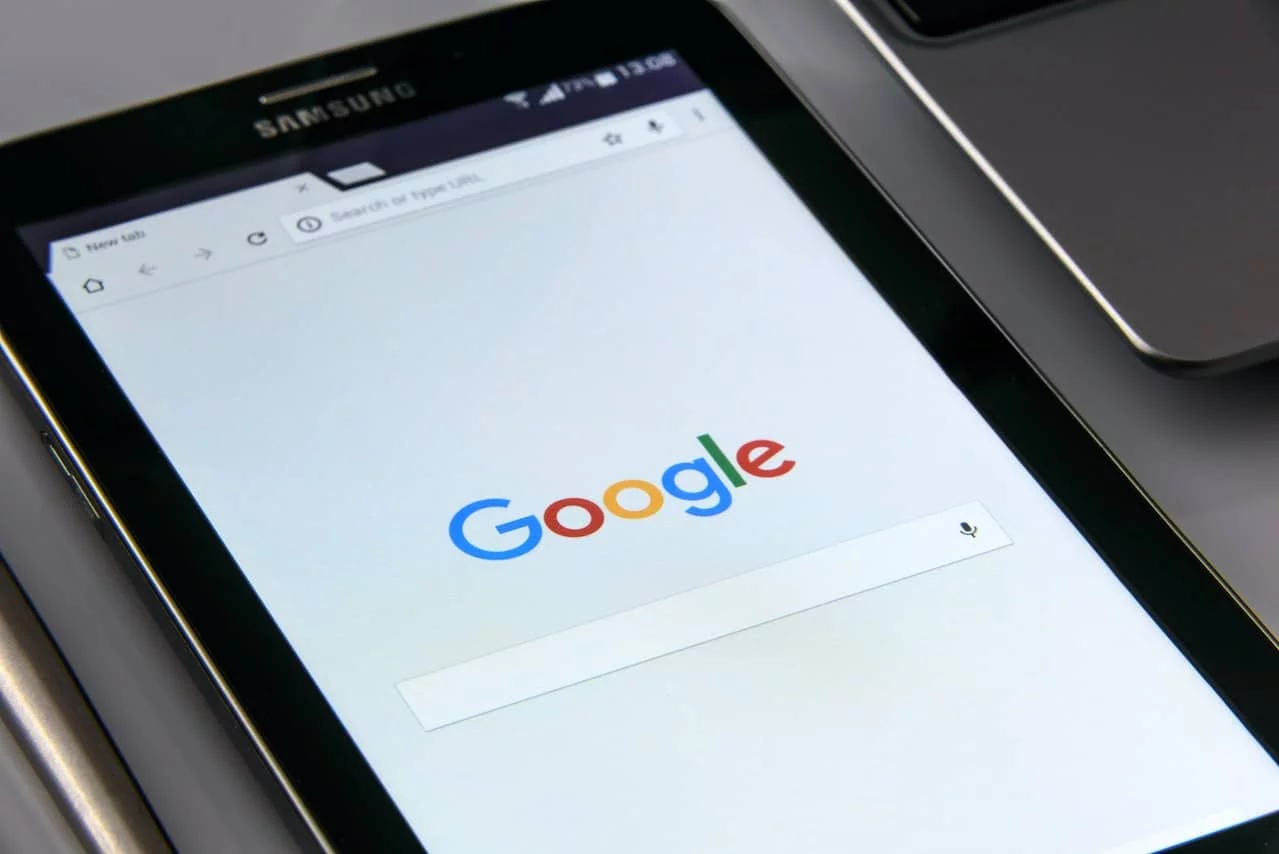 Close-up of a tablet displaying the Google home page