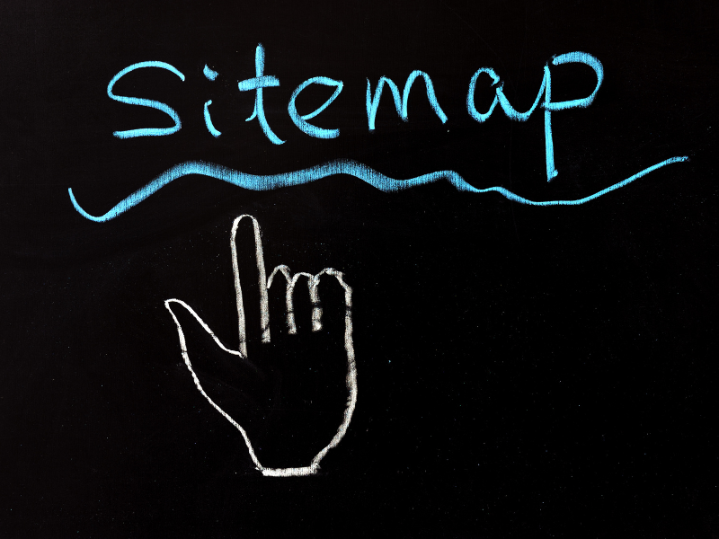 sitemap written on a chalkboard with a hand